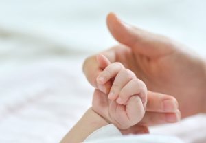 Hands of a new born baby and the mother